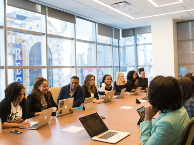 Coworkers sitting around a conference table at Circle Floors Inc, in Everett, MA